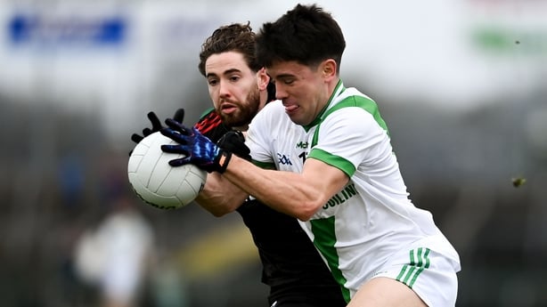 Maigh Cuilinn's Seán Kelly tries to get past the challenge of Eddie Nolan of St Brigid's