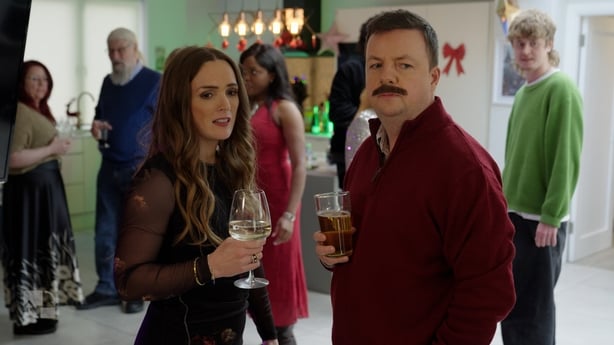 Emma Doran and Oliver Callan in character at a party