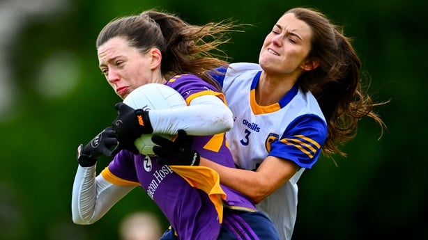 30 November 2025; Michelle Davoren of Kilmacud Crokes in action against Niamh McIntosh of St Ergnat's, Moneyglass during the 2025 AIB All-Ireland Ladies Football Club Senior Club Championship semi-final match between Kilmacud Crokes of Dublin and St Ergnat's of Antrim at Páirc de Burca in Stillorgan