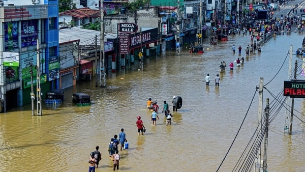 People walk through flood water