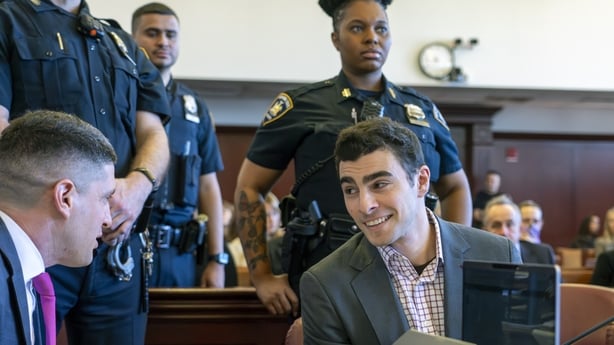 Luigi Mangione speaking to his lawyer in court