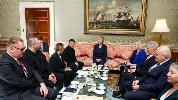 Catherine Connolly and Zelensky sit down at a table in the Áras