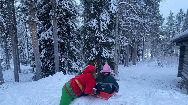 Child and elf in snow