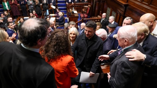 Volodymyr Zelensky is pictured being greeted by politicians following his address in the Dail chamber