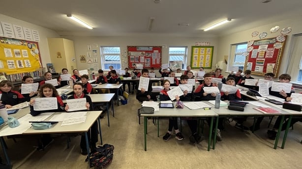 Pupils in Ballaghlea National School hold up census records.