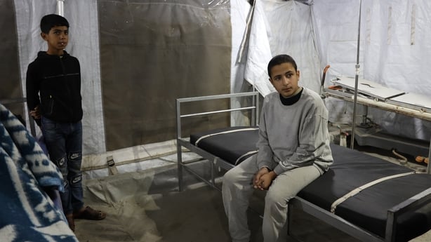DEIR AL BALAH, GAZA - DECEMBER 2: A child, who was detained during the Israeli army's attacks on the Gaza Strip, is escorted by Red Cross teams through the Kerem Abu Salim Border Crossing to the Al-Aqsa Martyrs Hospital after being released in Deir Al Balah, Gaza on December 2, 2025. (Photo by Abdal