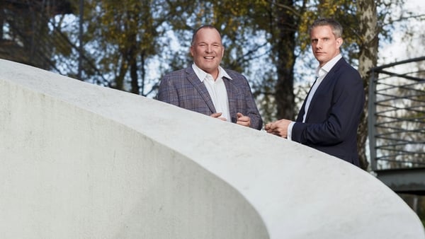 2 business men pictured on a outdoors staircase