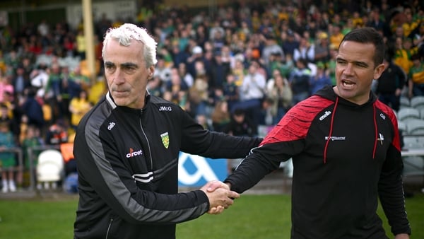 Donegal manager Jim McGuinness, left, shakes hands with Louth manager Ger Brennan after the GAA Football All-Ireland Senior Championship preliminary quarter-final match between Donegal and Louth at MacCumhaill Park in Ballybofey, Donegal.