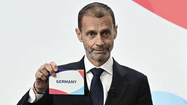 UEFA president Aleksander Ceferin shows the name of Germany, elected to host the UEFA Women's EURO 2029 fooball tournament during an announcement ceremony at the UEFA headquarters, the House of European Football, in Nyon on December 3, 2025.