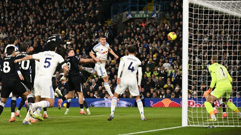 Leeds United's Slovenian defender Jaka Bijol (c) heads the ball to score