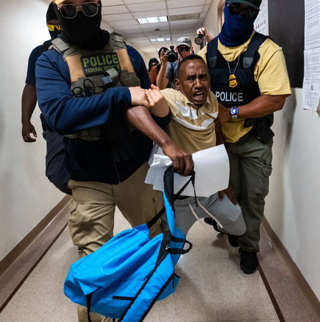 US federal agents, including members of ICE, drag a man away after his immigration court hearing at the Jacob K. Javitz Federal Building in New York on 24 July