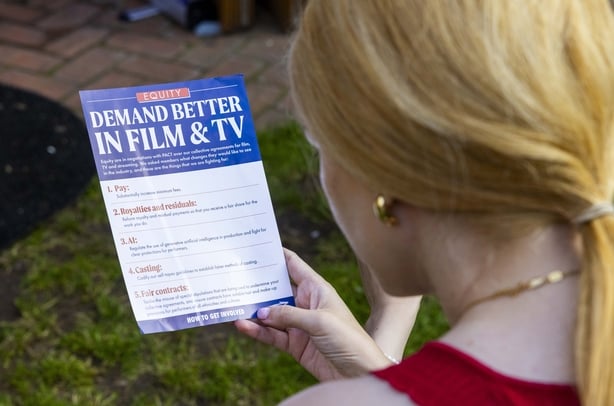 Undated handout photo issued by Equity of a woman reading a Demand Better leaflet. TV and film performers are to vote on strike action over scanning for artificial intelligence (AI). Actors union Equity is to hold the vote from December 4 to December 18 on whether members are prepared to refuse to b