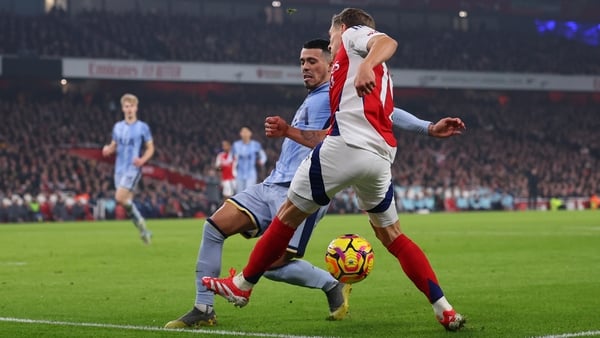 LONDON, ENGLAND - JANUARY 15: Leandro Trossard of Arsenal kicks the ball against Pedro Porro of Tottenham Hotspur which subsequently deflects from the leg of Trossard, sending the ball out of play for which Referee Simon Hooper awards a corner to Arsenal