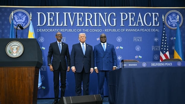 Presidents of US, Congo and Rwanda stand in front of a sign 