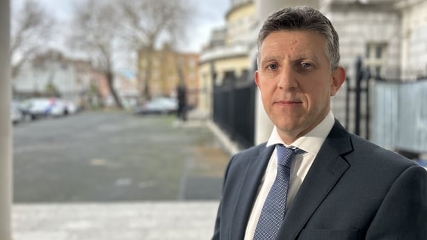 Martin O'Keefe stands in an outdoor area.