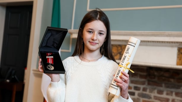 Carla Murphy holds up her two awards.