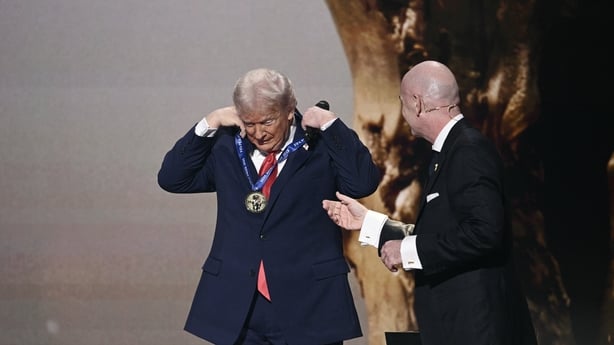 US President Donald Trump is awarded a medal on stage