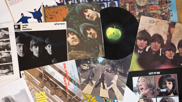 collection of posters and vinyl records from The Beatles