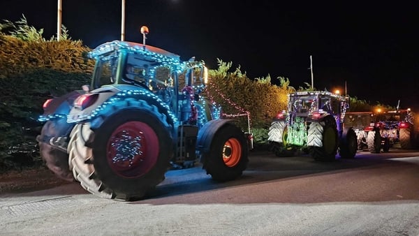 Tractors drive along a country road