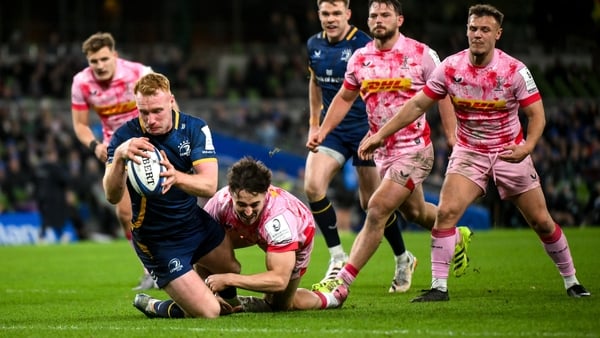 6 December 2025; Ciarán Frawley of Leinster scores his side's fourth try despite the tackle of Cadan Murley of Harlequins during the Investec Champions Cup match between Leinster and Harlequins at the Aviva Stadium in Dublin. Photo by Shauna Clinton/Sport