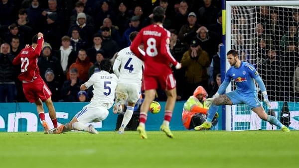 Hugo Ekitike of Liverpool scores his team's first goal past Lucas Perri of Leeds United during the Premier League match between Leeds United and Liverpool at Elland Road on December 06, 2025 in Leeds, England. (Photo by Molly Darlington/Getty Images)