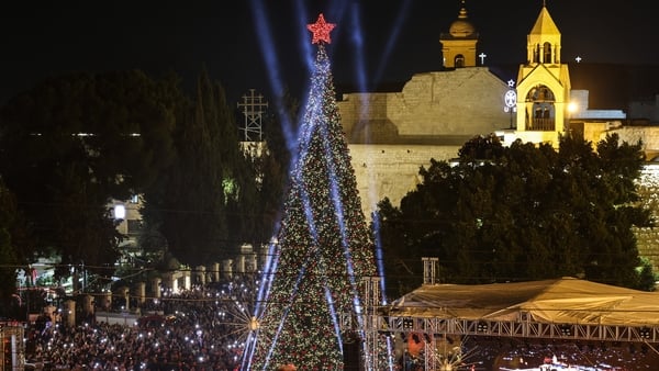 Spectators gather on Nativity Square during a Christmas tree lighting ceremony in Bethlehem, in the Israeli-occupied West Bank