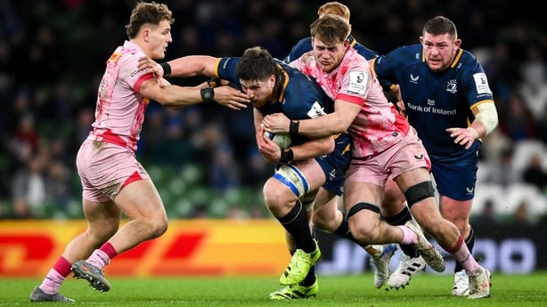 Joe McCarthy of Leinster is tackled by Harlequins players Cassius Cleaves, left, and Zach Carr during the Investec Champions Cup match between Leinster and Harlequins at the Aviva Stadium in Dublin. (Photo By Shauna Clinton/Sportsfile via Getty Images)