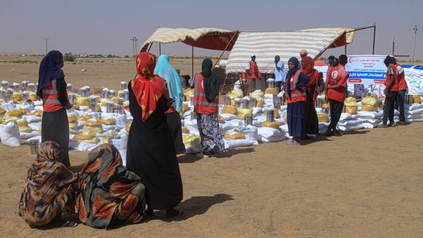 Sudanese women who fled El-Fasher wait to receive humanitarian aid at the Al-Afad camp for displaced people in the town of Al-Dabba, northern Sudan, on November 25, 2025