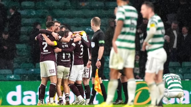 Celtic players look dejected as Hearts players celebrate victory in Scottish Premiership clash in December 2025