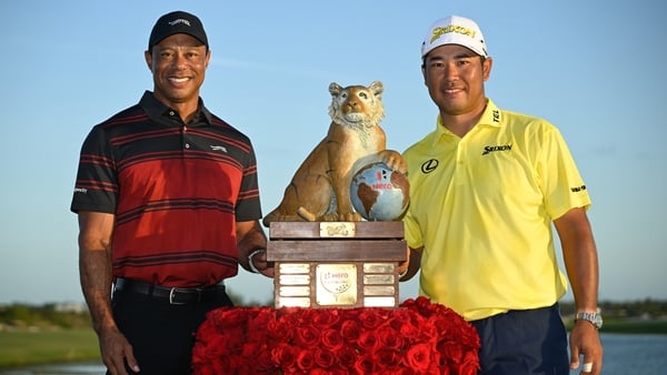 Tiger Woods and Hideki Matsuyama of Japan stand with the trophy on the 18th green after the final round of the Hero World Challenge at Albany Golf Course on December 7, 2025 in Naussau
