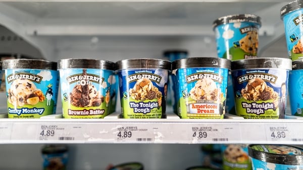 Ben & Jerry's ice cream containers on shelves in a fridge