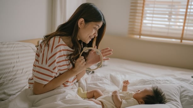 mother playing music for her baby