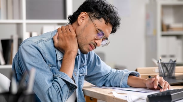 Businessman having neck ache and shoulder pain while working in the office, Office syndrome concept