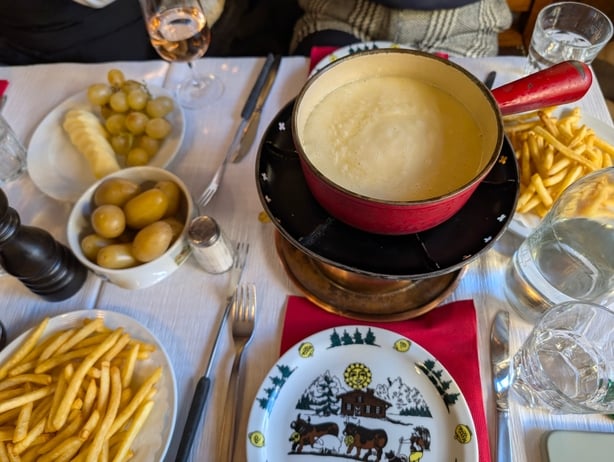 A table with a pot of cheese fondue