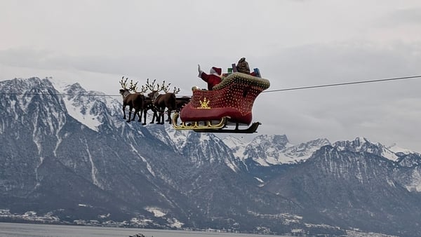 A photo of Santa's sleigh against a mountain backdrop