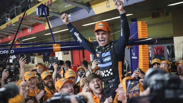 Lando Norris the new F1 World Drivers Champion and 3rd placed in the race of Abu Dhabi Grand Prix 2025 of McLaren celebrates in the after party in front of the pits the title with his team, teammates, engineers and McLaren's Boss Zak Brown after posing fo