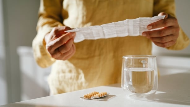 Mature woman taking vitamins