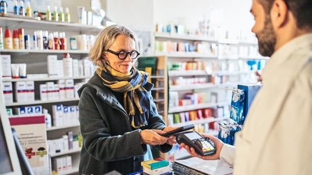 woman paying using her phone