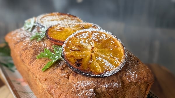A loaf cake with orange slices on top