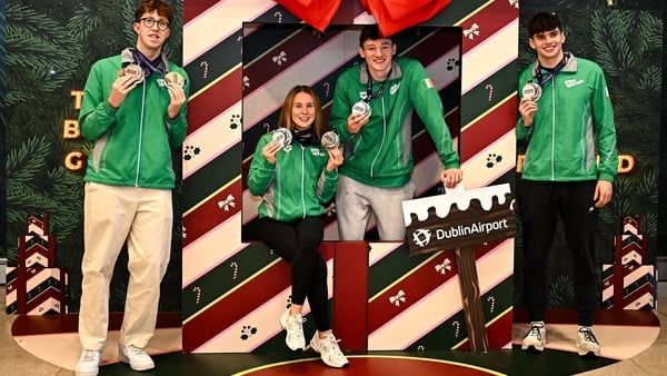 8 December 2025; Team Ireland swimmers, from left, Daniel Wiffen, Ellen Walshe, John Shortt and Evan Bailey with their medals at Dublin Airport on return from the European Short Course Swimming Championships at Lublin in Poland. Photo by Piaras Ó Mídheach