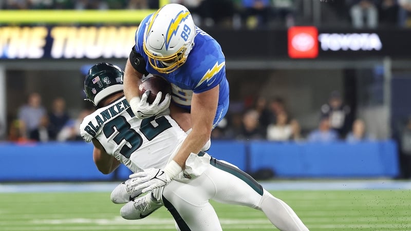 Reed Blankenship of the Philadelphia Eagles, left, tackles Los Angeles Chargers tightend Will Dissly