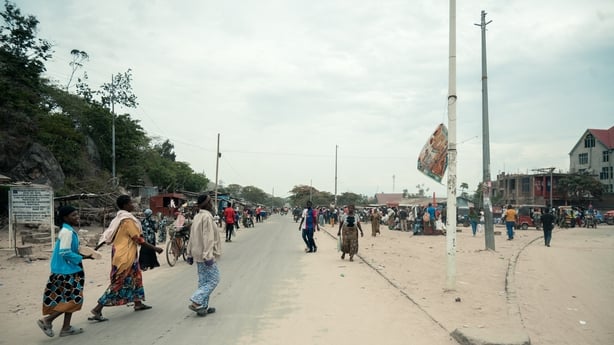 Commuters walk along a road in Uvira in DR Congo