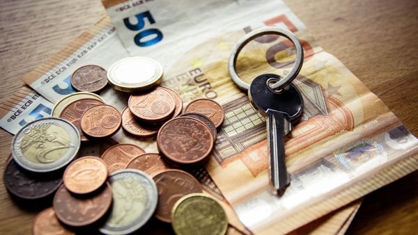 Photo shows key, money, housing crisis