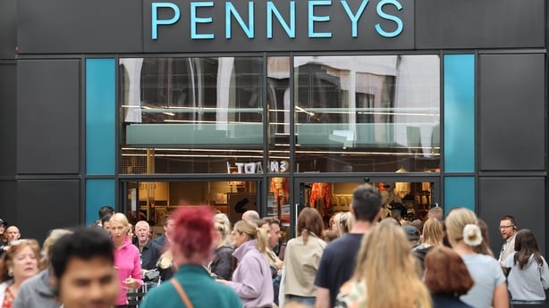 An image of a Penneys shop with people moving outside of it