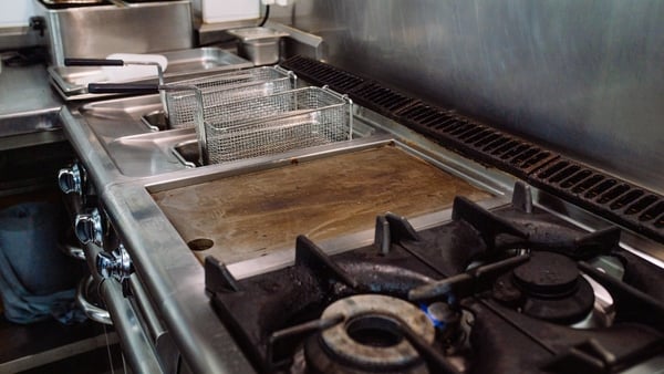 stoves, griddles and fryers without food in a restaurant kitchen