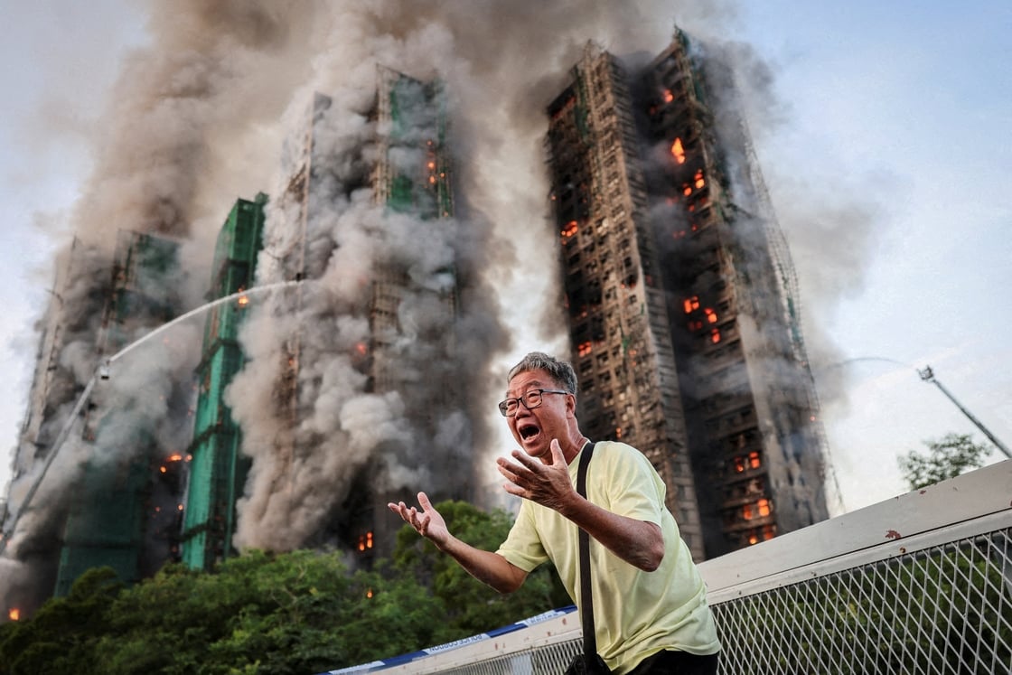 A 71-year-old man reacts as the blaze takes hold, saying his wife is trapped inside the complex