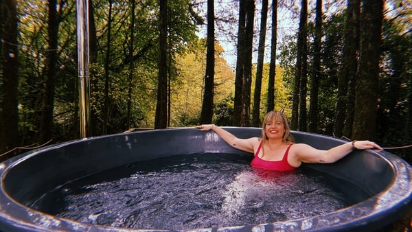 Tara Povey in a forest hot tub at Barrow Sauna Laois landscape
