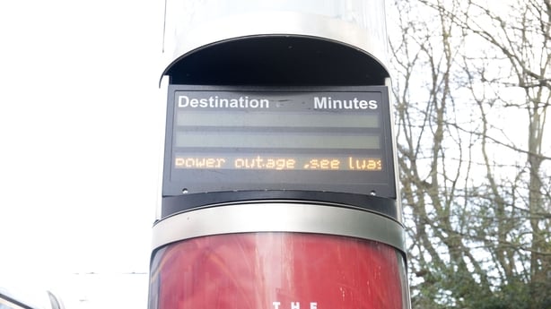 a sign reads power outage on a Luas information board