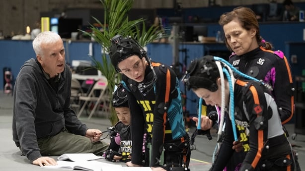 (L-R) Director James Cameron, Trinity Bliss, Britain Dalton, Jack Champion, and Sigourney Weaver on the set of Avatar: Fire and Ash. Photo by Mark Fellman
