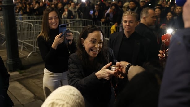 Nobel peace laureate Maria Corina Machado receives gifts from supporters gathered outside the Grand Hotel in Oslo